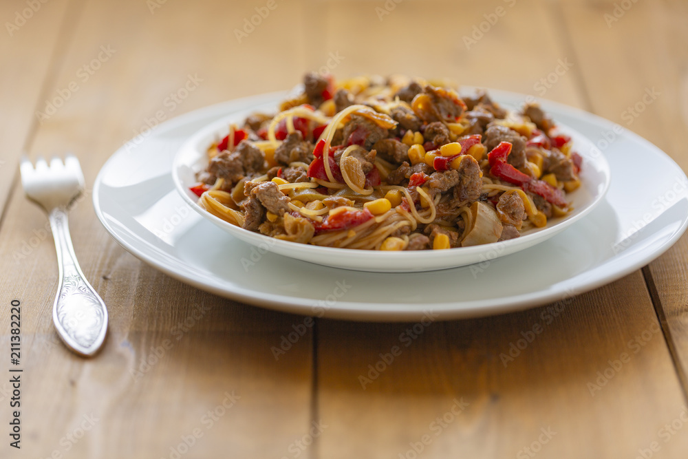 Noodles with meat and vegetables  in sweet and sour sauce.