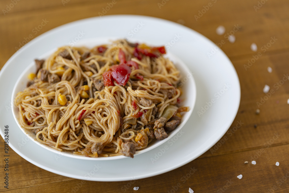 Noodles with meat and vegetables  in sweet and sour sauce.