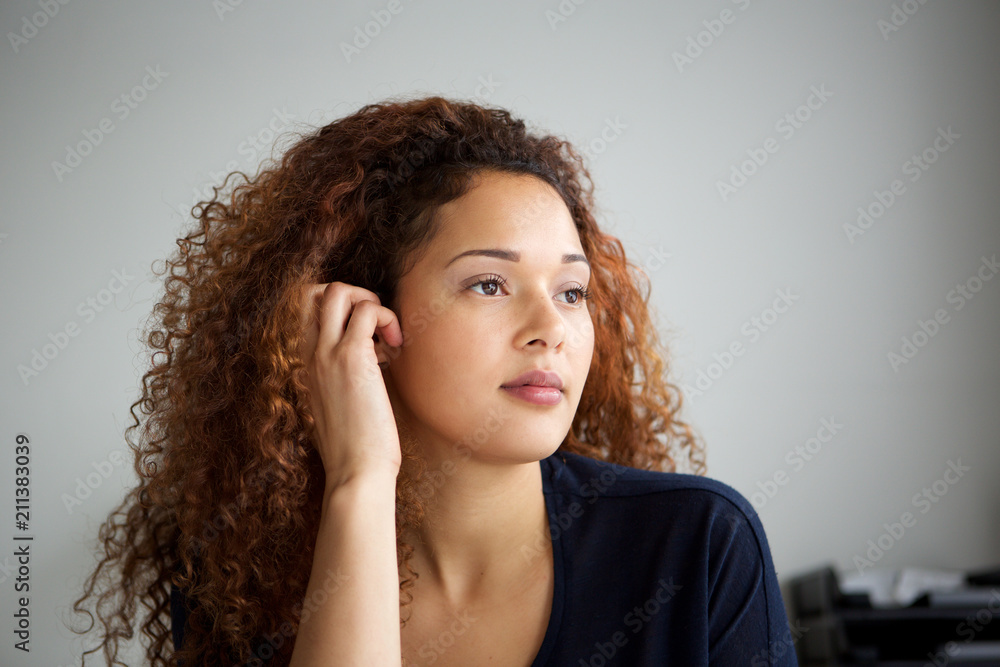 Close up beautiful mixed race woman thinking and looking away Close up beautiful mixed race woman thinking and looking away