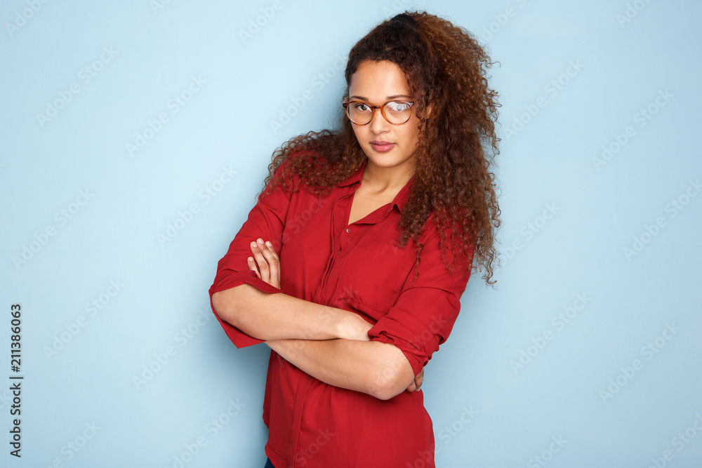 african american woman with glasses by blue wall african american woman with glasses by blue wall