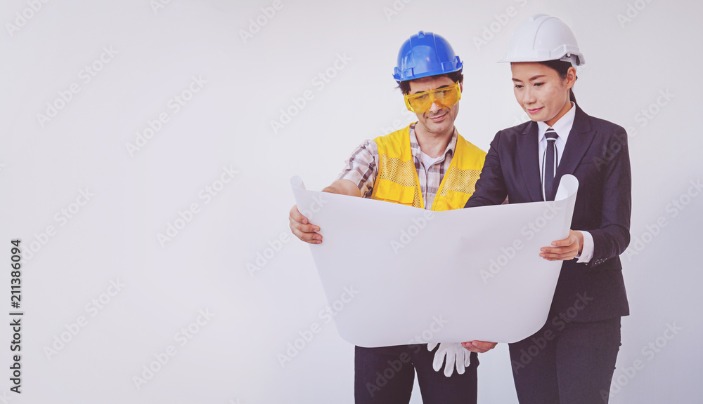 Construction manager and engineer looking at blueprints