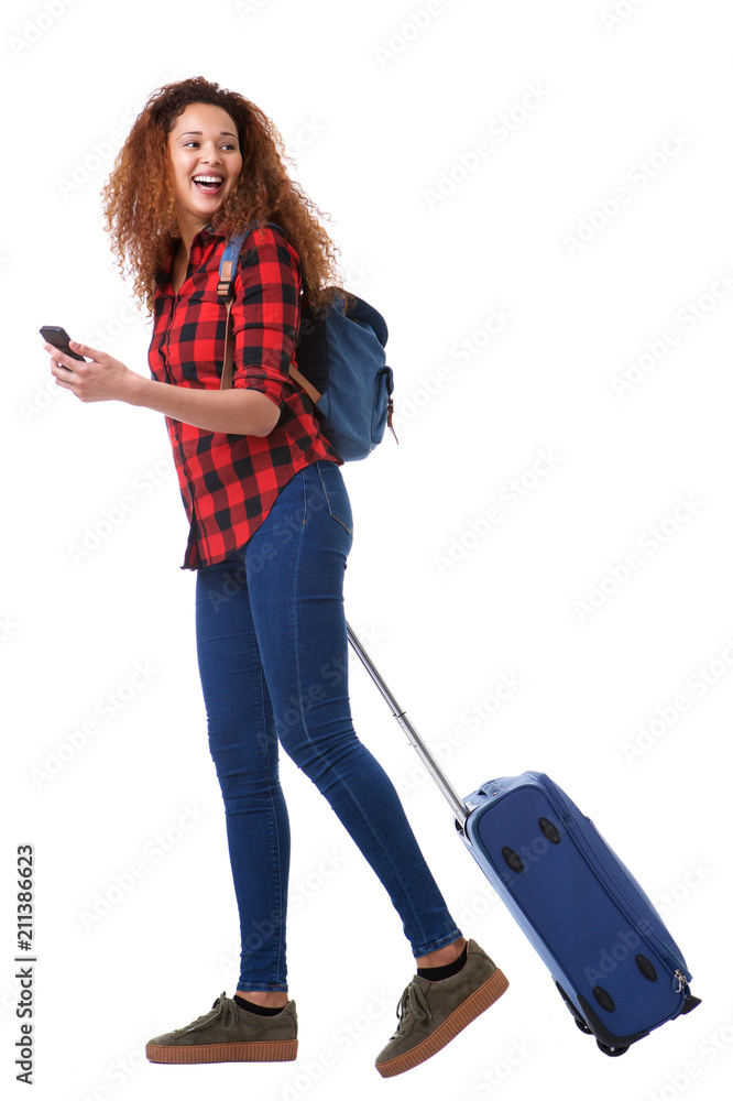 Full body happy travel woman walking with suitcase and mobile phone Full body happy travel woman walking with suitcase and mobile phone