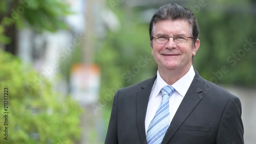 Wallpaper Mural Happy handsome senior businessman in the streets outdoors Torontodigital.ca
