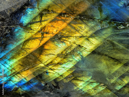 Amazing colorful texture of iridescence Labradorite Mineral gemstone background macro close-up. Beautiful reflective shiny Crystal