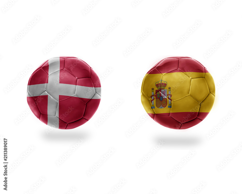 Obraz premium football balls with national flags of denmark and spain.