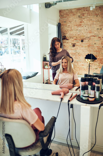 Young blonde women smiling during a hair salon appointment