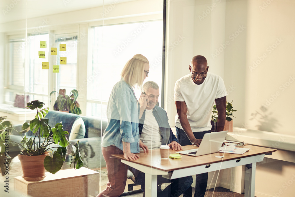 Smiling diverse colleagues working together in a modern office Smiling diverse colleagues working together in a modern office