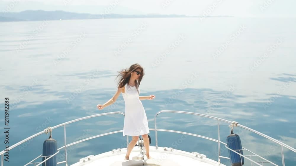 Young attractive and rich woman having fotosession on a luxury boat in sea Young attractive and rich woman having fotosession on a luxury boat in sea