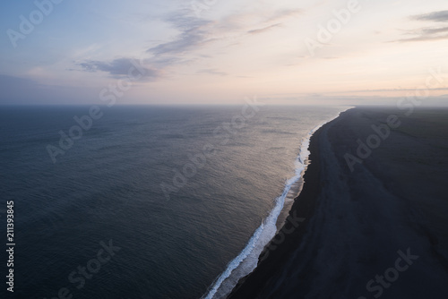 Ocean and shore with black sand