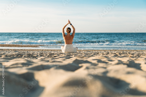 Woman meditating on beach