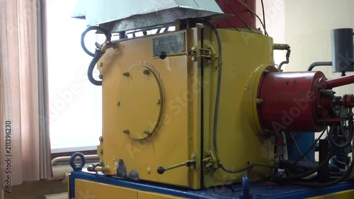 Operator Unloads the Metallic Dental Prosthesis from an Old Ionic-Plasma Deposition System