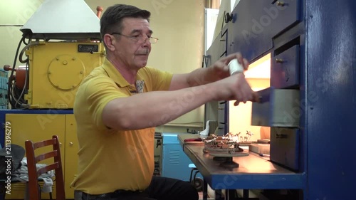 Operator Works with Metallic Dental Prostheses Agter Ionic-Plasma Deposition with Gold