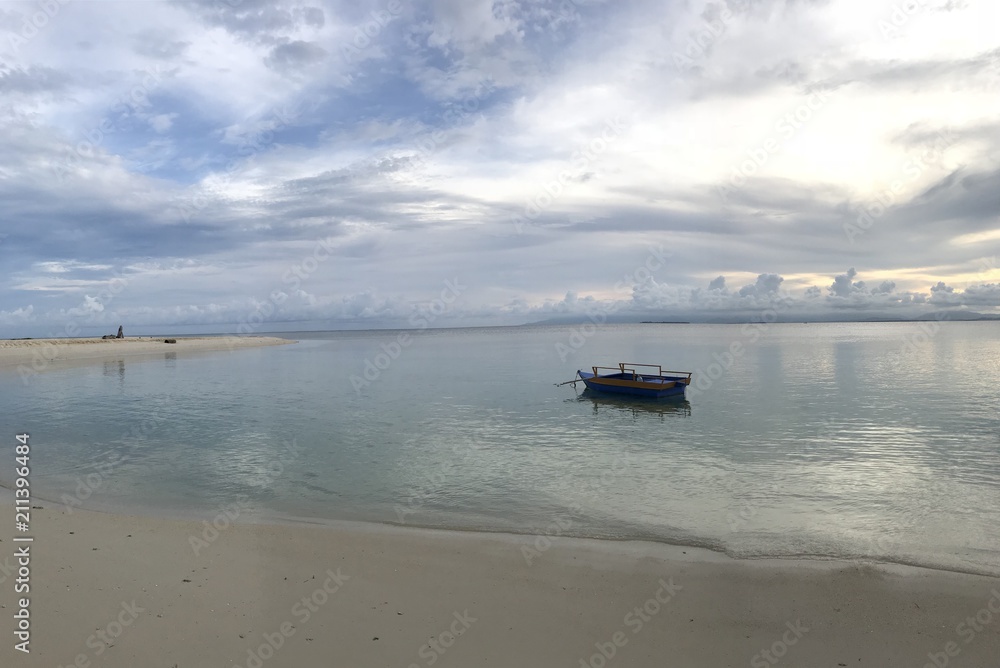 Small boat on a white sand beach during sunset, Modessa Island, Palawan, Philippines Small boat on a white sand beach during sunset, Modessa Island, Palawan, Philippines