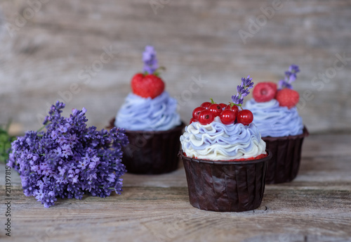 beautiful homemade cupcakes with purple cream and a bouquet of lavender photo