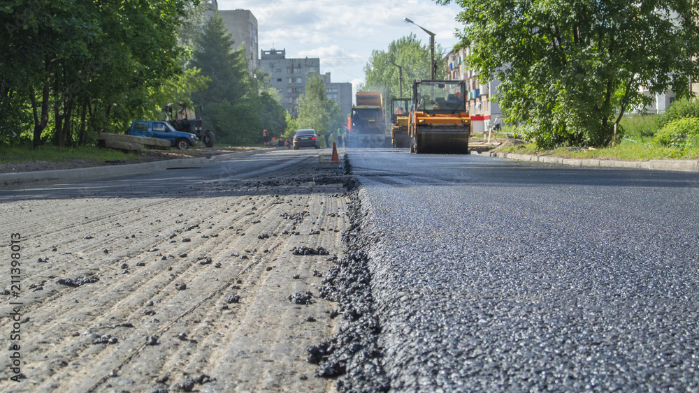 Repair works on laying the asphalt surface on a city street. Steamroller machine for laying asphalt Repair works on laying the asphalt surface on a city street. Steamroller machine for laying asphalt