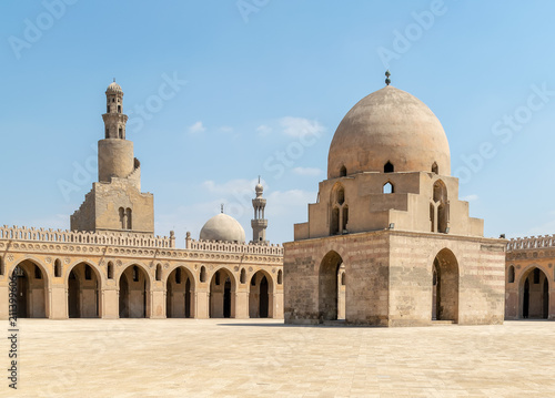 Courtyard of Ibn Tulun public historical mosque, Cairo, Egypt. View showing the ablution fountain, the minaret and the minaret of Sarghatmish mosque