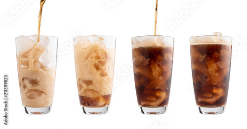 Pouring Coca Cola into glass Isolated white background, clipping path