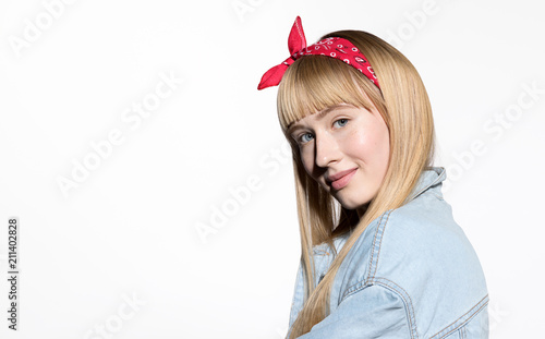 Portrait of happy cheerful girl with engaging appearance posing at studio. Cute young woman with stylish hairdo and delicate make-up looking at camera with gladness and calmness