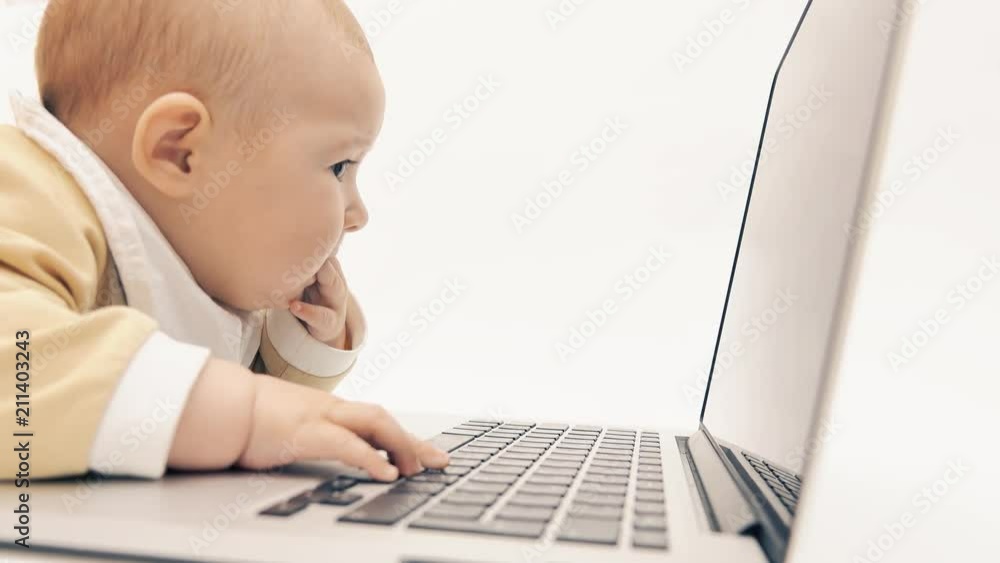Funny baby watching video on a laptop Funny baby watching video on a laptop