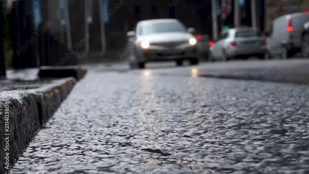 Rain in Rush Hour creates flood. The car moves past the camera. Selective focus. Rain in Rush Hour creates flood. The car moves past the camera. Selective focus.