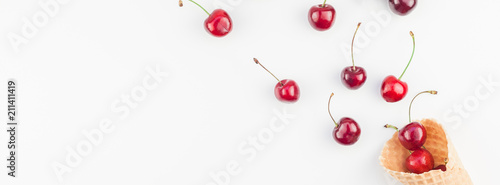 Ripe cherries in a waffle cone isolated