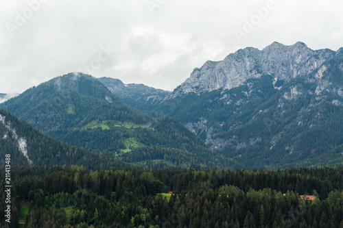View on rocky Dachstein mountain peaks hills and forests from the balcony of the apartment