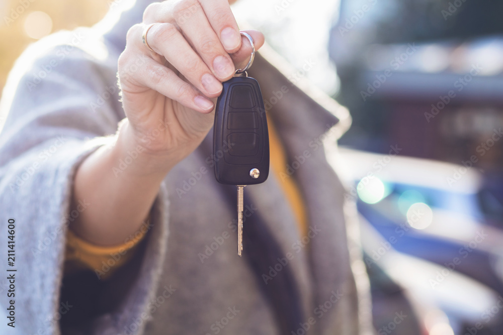 Woman holding new car key.