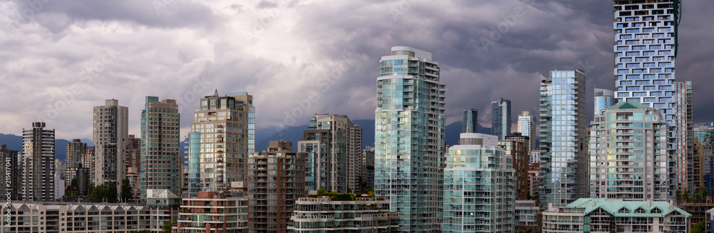 Panoramic view of Downtown City Buildings during a vibrant evening. Taken in Vancouver, British Columbia, Canada.