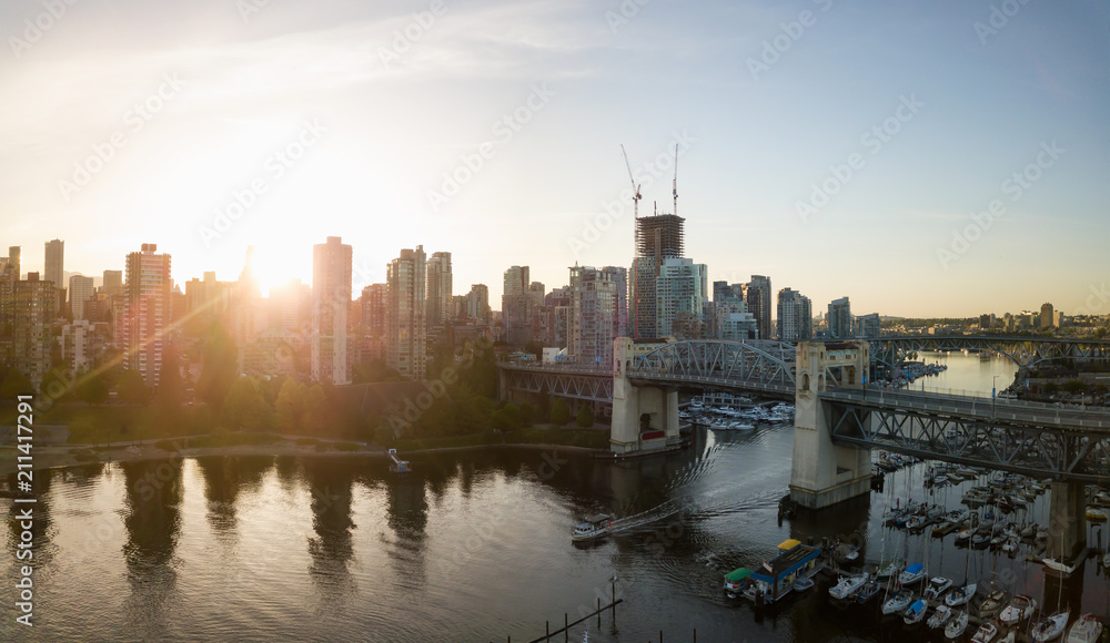Fototapeta premium Aerial panoramic view of Burrard Bridge in False Creek During a vibrant sunrise. Taken in Downtown Vancouver, BC, Canada.