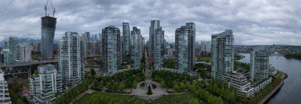 Fototapeta premium Aerial view of high rise buildings in Downtown City during a cloudy sunrise. Taken in Vancouver, BC, Canada.