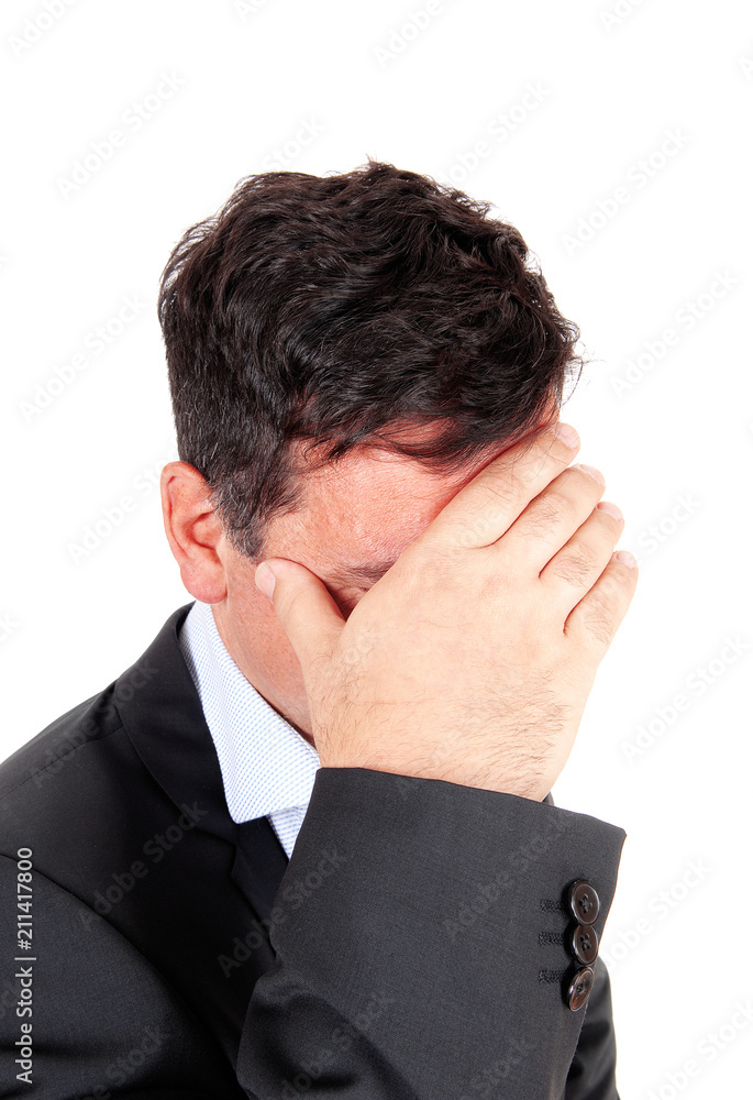 Business man covering is face he is depressed Business man covering is face he is depressed