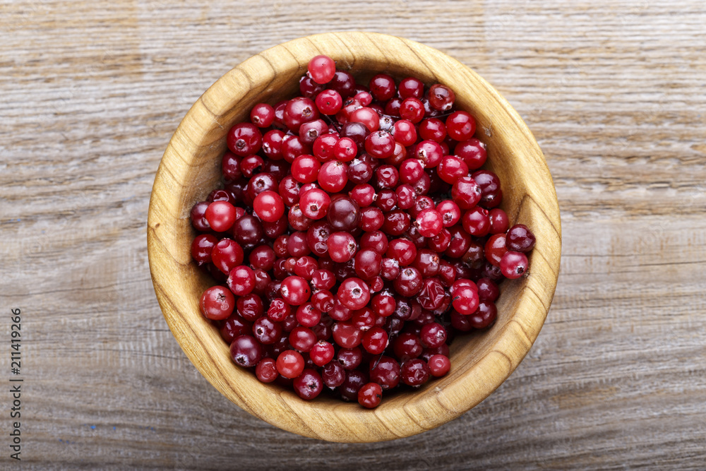 cranberries in a wooden plate cranberries in a wooden plate