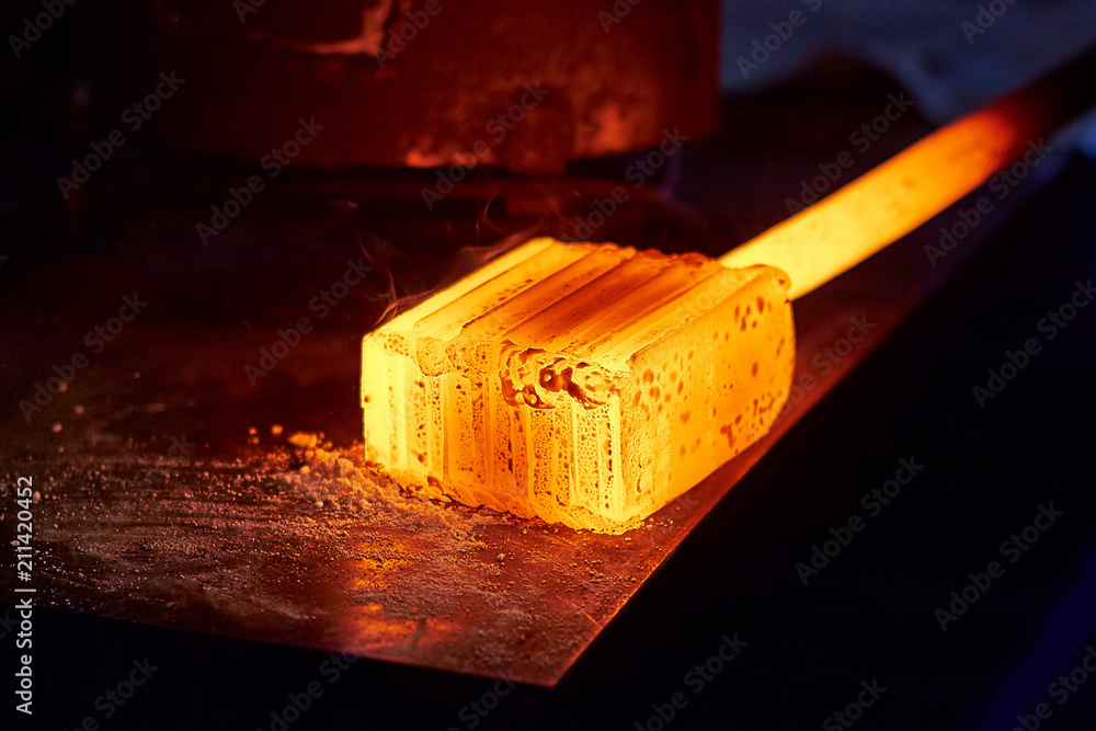 Glowing iron ingot on the table. Hot metal workpiece for the manufacture of  Damascus steel. Stock Photo | Adobe Stock