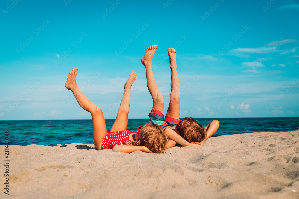 little boy and girl relax on tropical beach