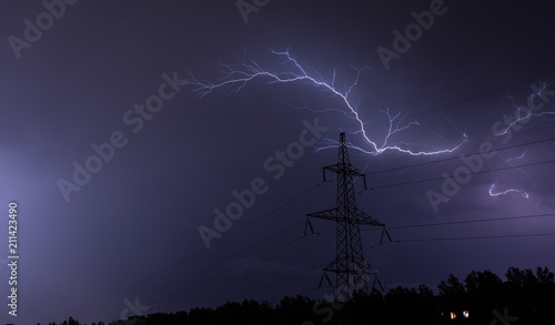 Lightning strike charge on the dark sky at power line electricity