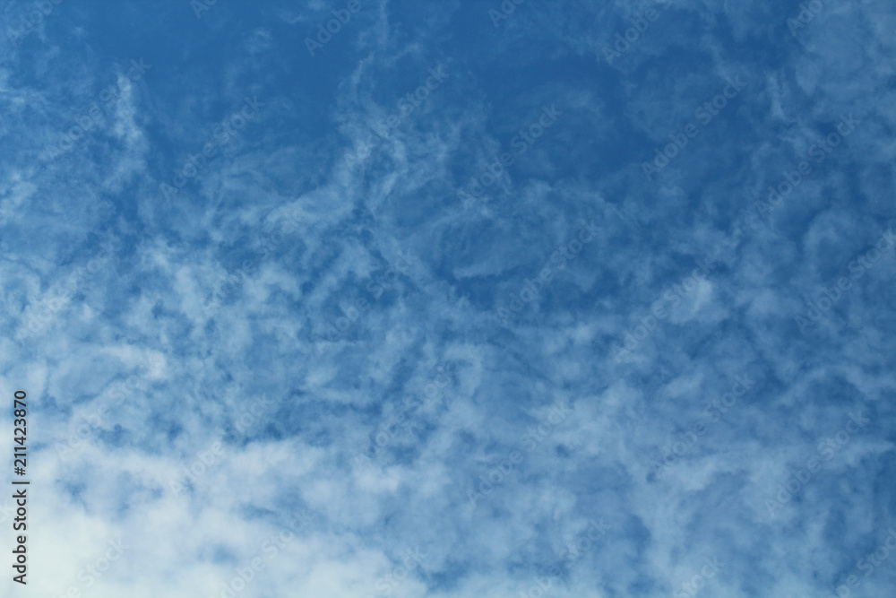 A beautiful blue sky and smoky white cirrus clouds. Background. Texture. Landscape.