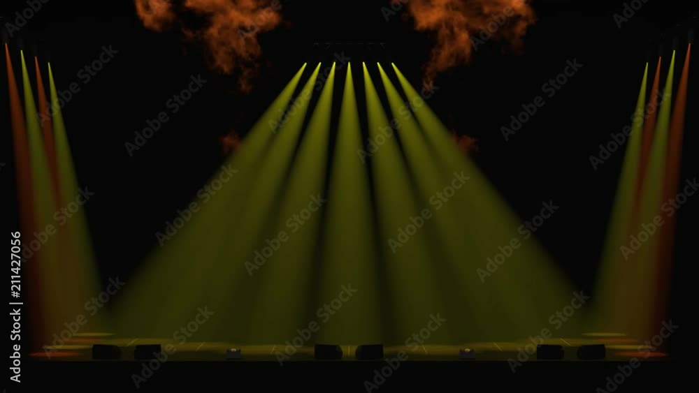 Yellow and orange spotlights down onto a stage with a fire show at ...