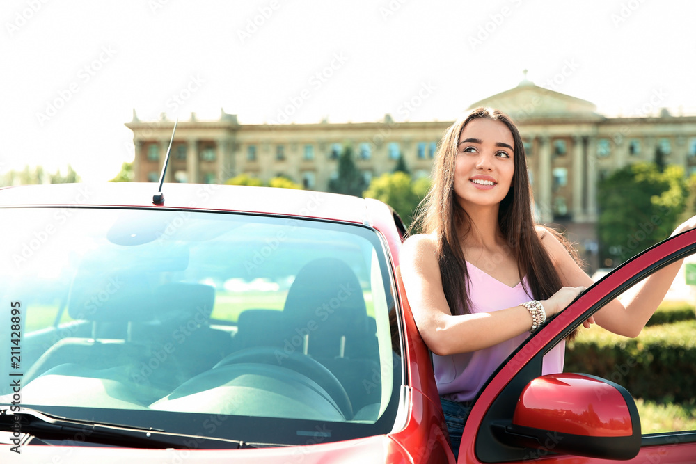 Young woman near car outdoors on sunny day