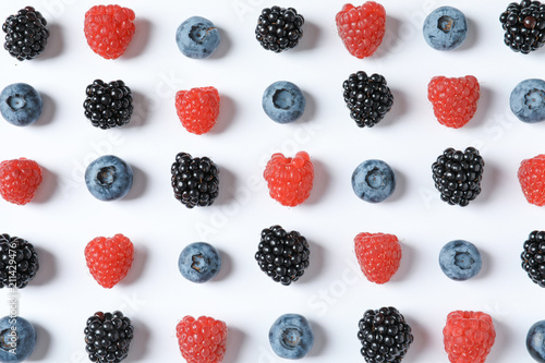 Composition with raspberries, blackberries and blueberries on white background
