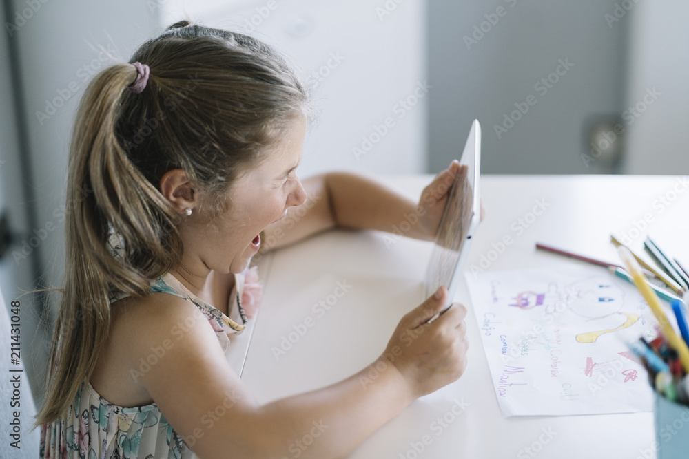 Little girl using a tablet at home Little girl using a tablet at home