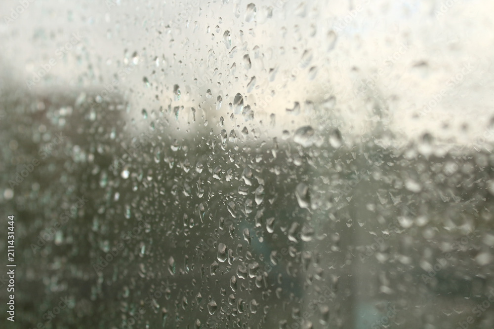 Wet, clear glass after the rain. Rain drops on the glass. Close-up. Background. Texture. Wet, clear glass after the rain. Rain drops on the glass. Close-up. Background. Texture.
