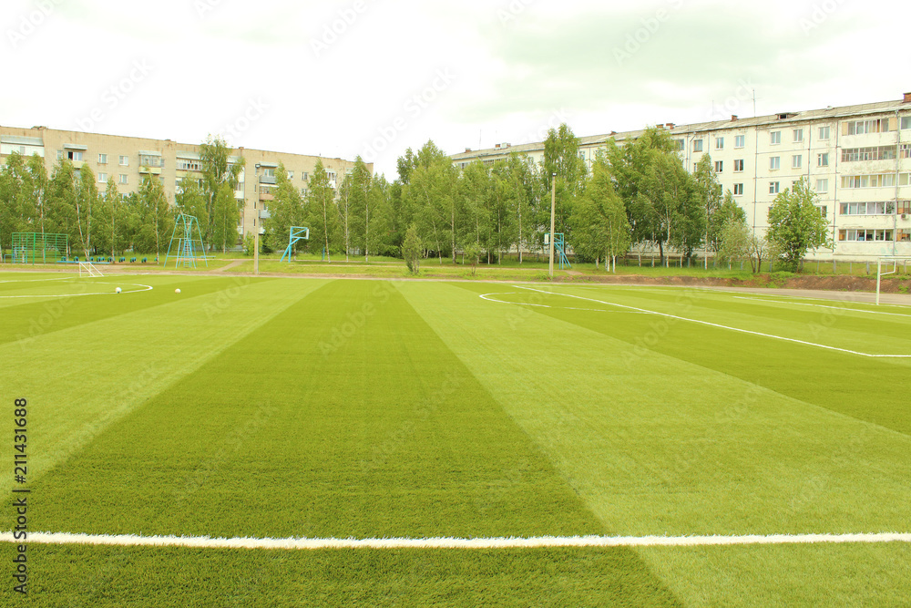 Green artificial football field. The school stadium. Background.