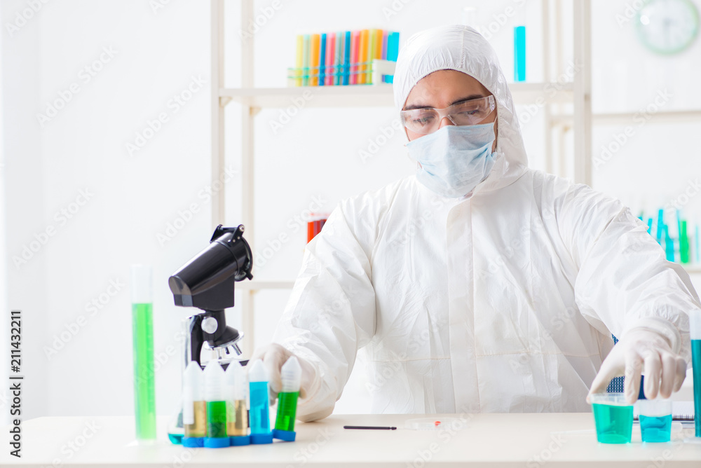 Young chemist student working in lab on chemicals Young chemist student working in lab on chemicals