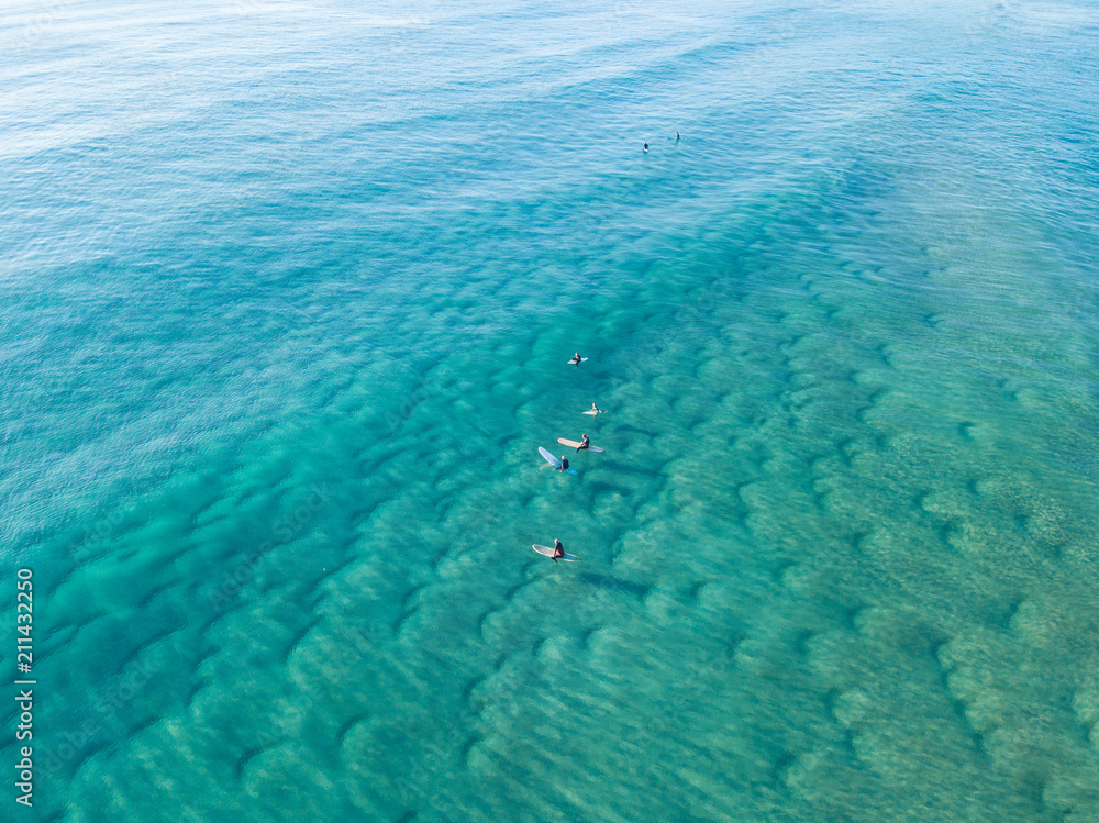 Fototapeta premium An aerial view of surfers waiting for a wave at the beach on the Gold Coast in Queensland Australia