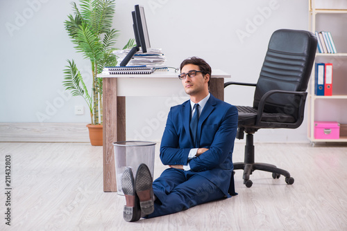 Young handsome businessman employee working in office in paperwo photo