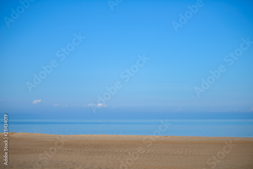 Fototapeta Naklejka Na Ścianę i Meble -  The background texture desert beach. A cloudless sky and sand