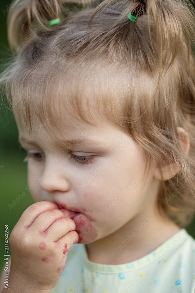little girl eats cherry in the garden little girl eats cherry in the garden