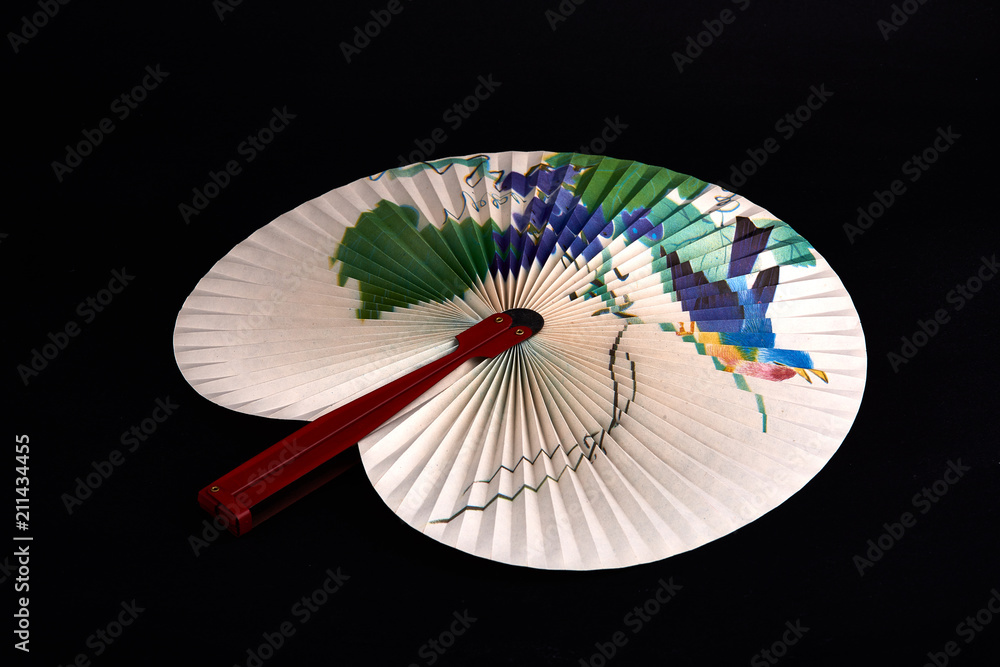 Closeup of Traditional Chinese paper fan on black  background.Hand paper fan