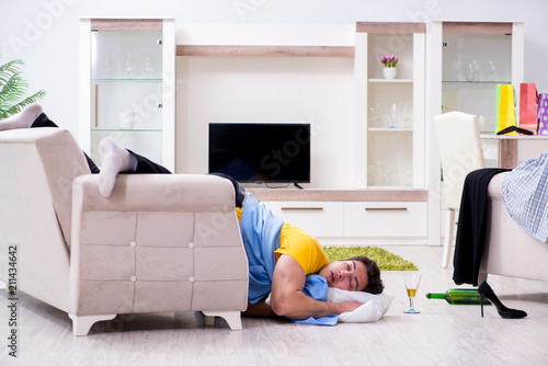 Man with mess at home after house party