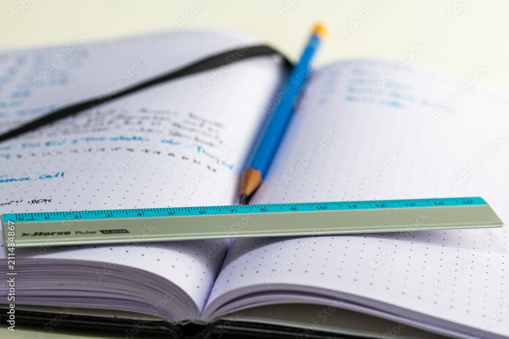 Notebook with writing, ruler, pencil, fountain pen Notebook with writing, ruler, pencil, fountain pen